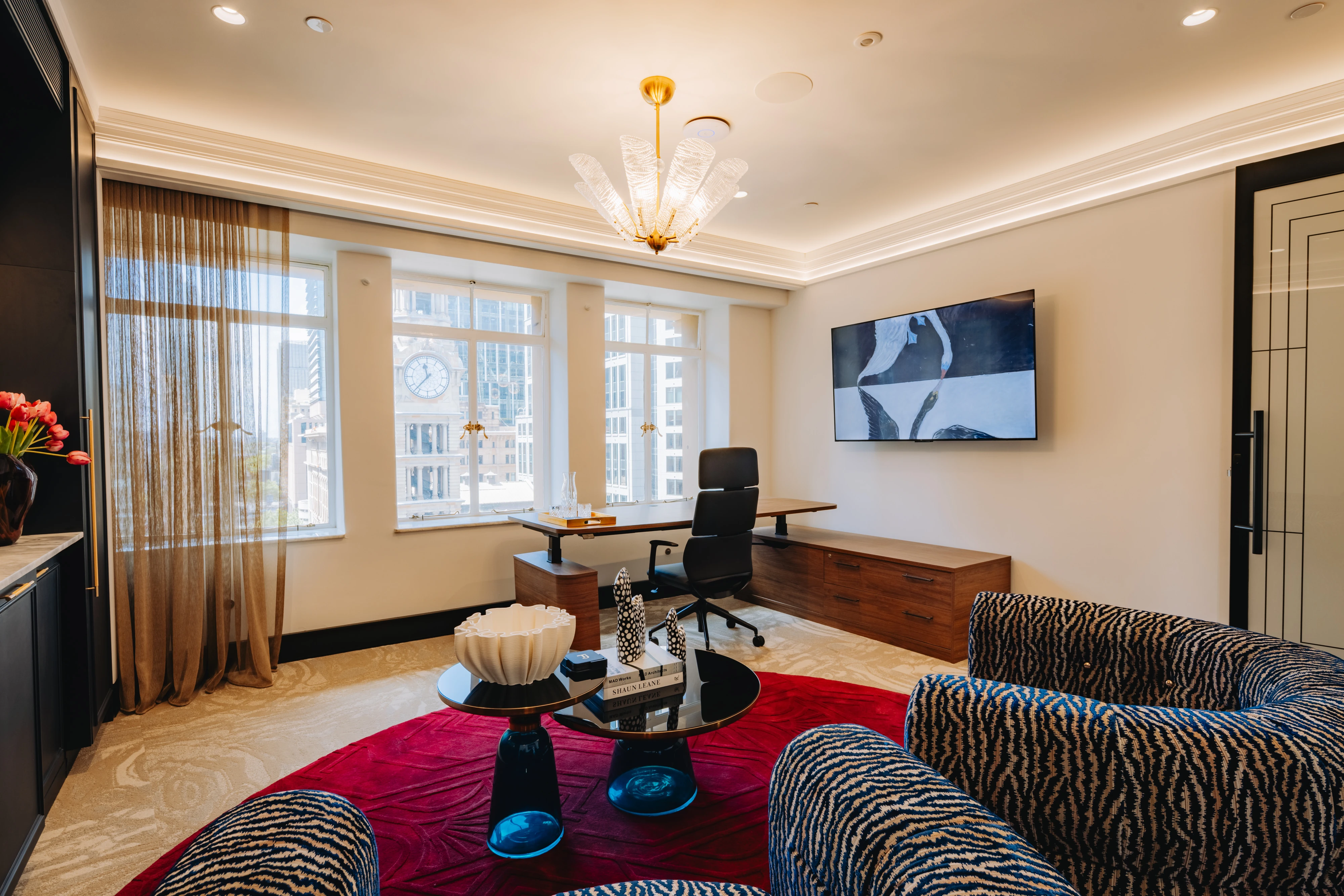 Executive suite with Anders chairs in napa leather beside rich timber surfaces and deep midnight-toned perimeter cabinetry