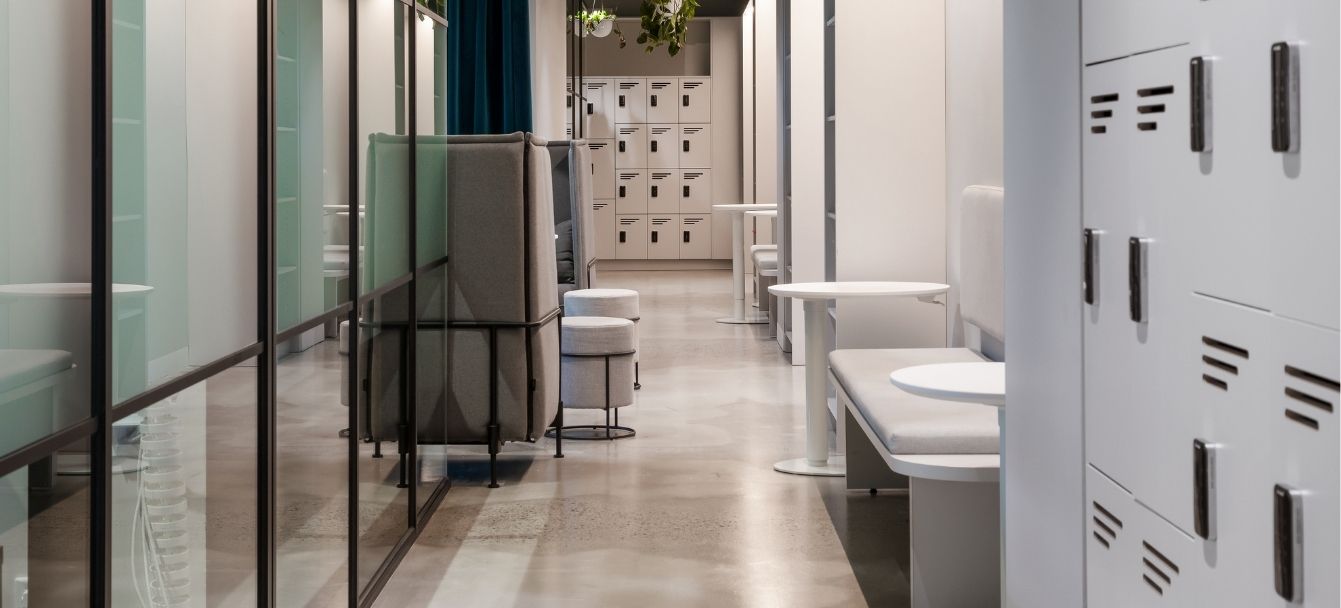 Office hallway lined with Universal lockers and glazed rooms