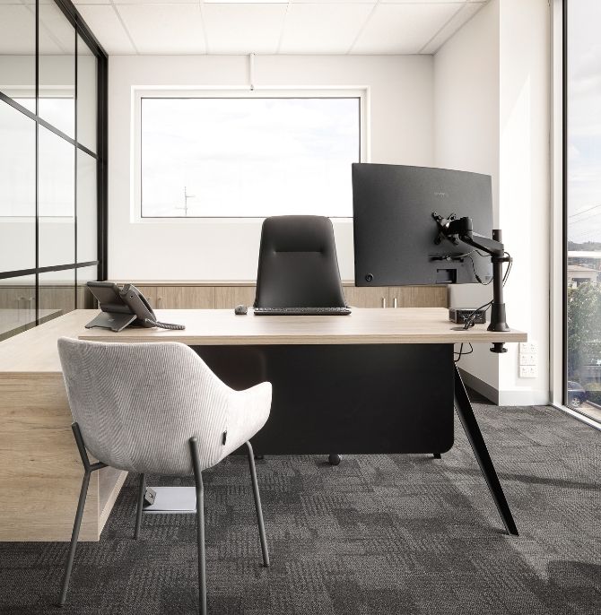 Executive office with a Dart desk, black task chair and grey guest chair