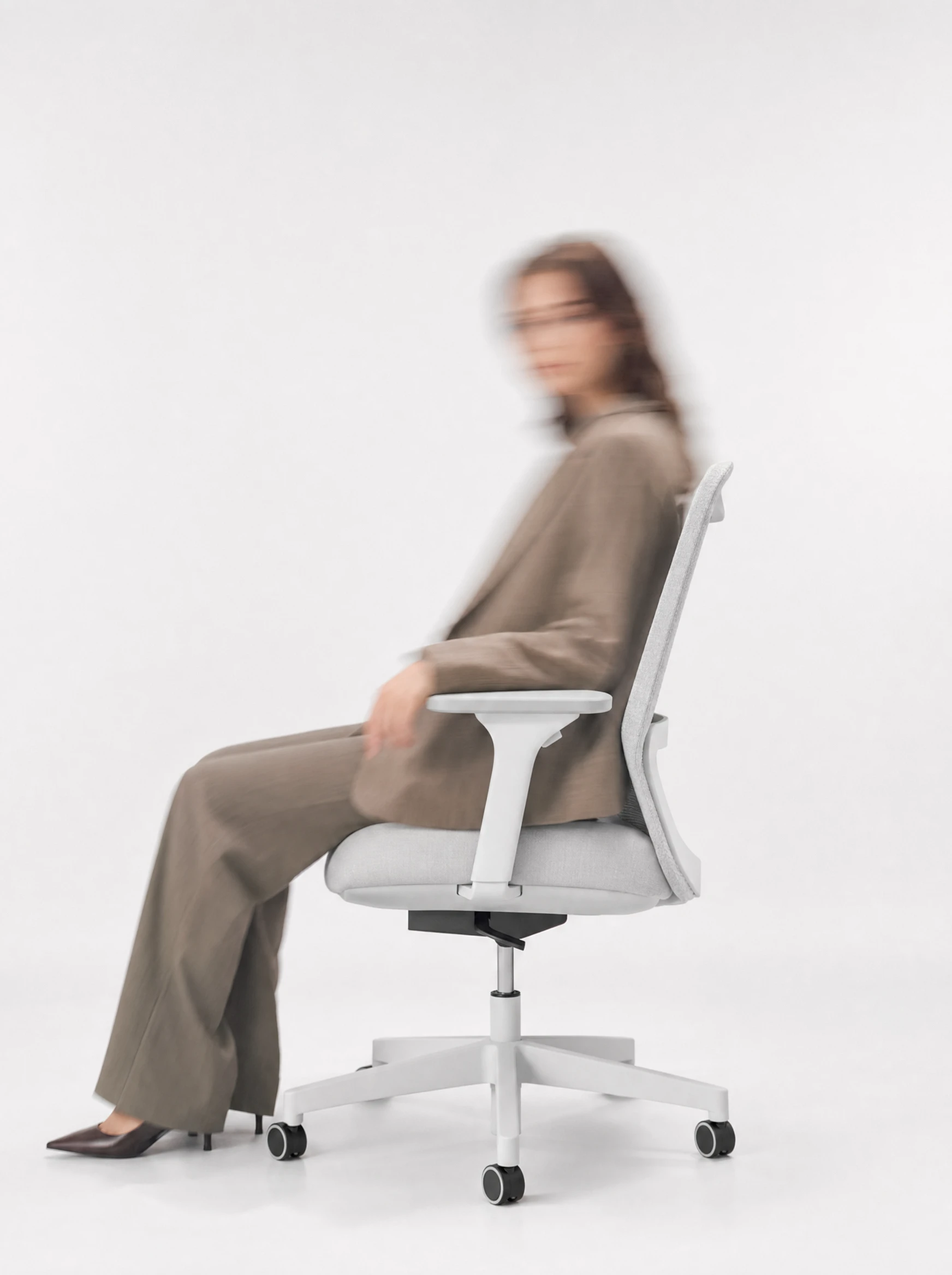 Cortex in profile mid-recline, motion suggested by slight blur on the background, sitter relaxed, side-on…