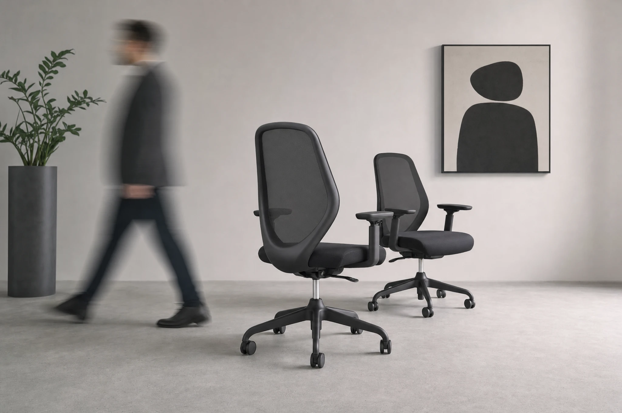 A long row of Ohvi chairs in a young company’s office, morning light, energy of a growing team