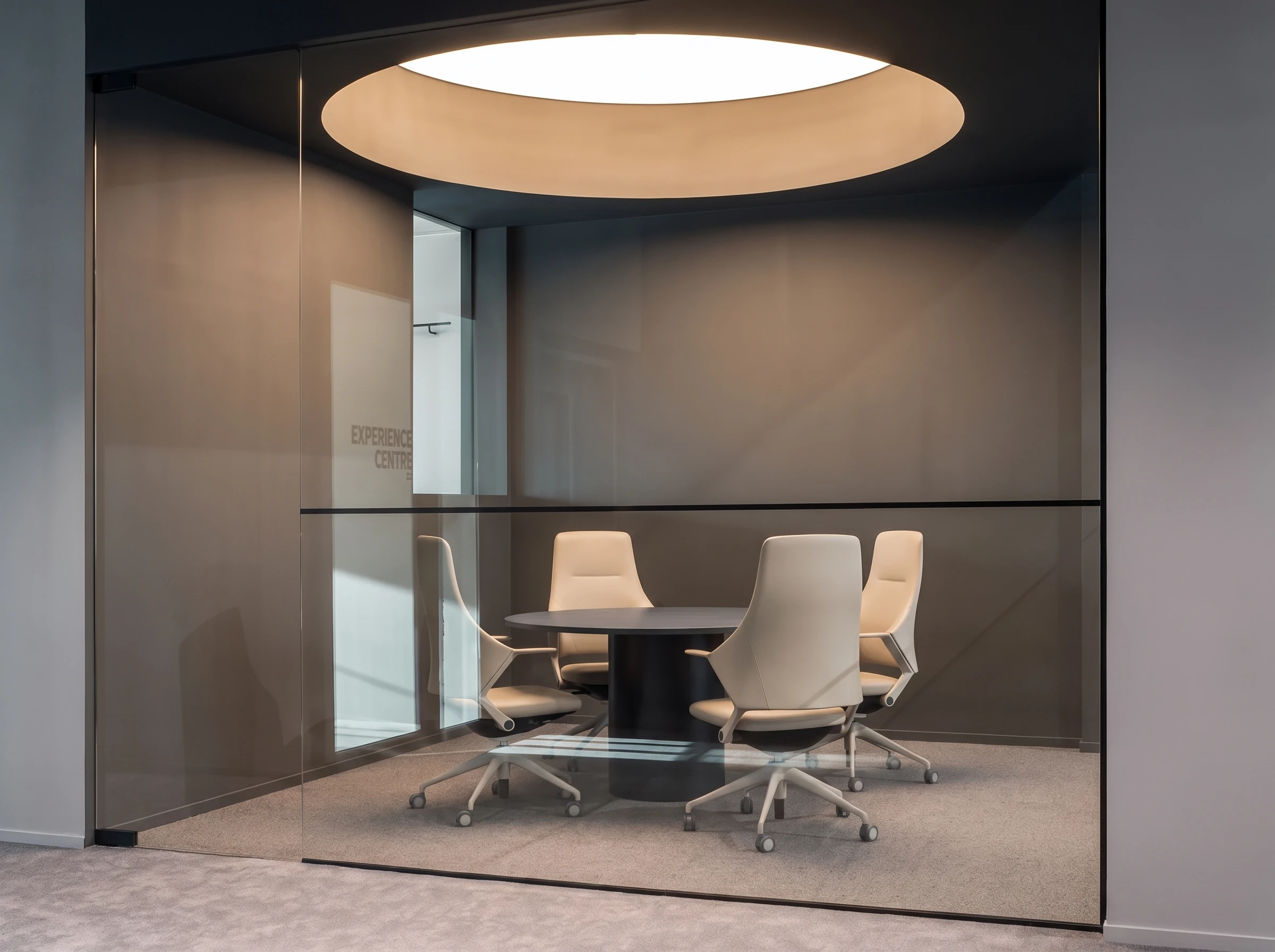 Mocha Otto in a client meeting suite with warm timber and brass accents